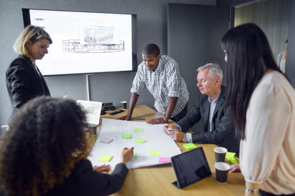 Architects discussing blueprint in office