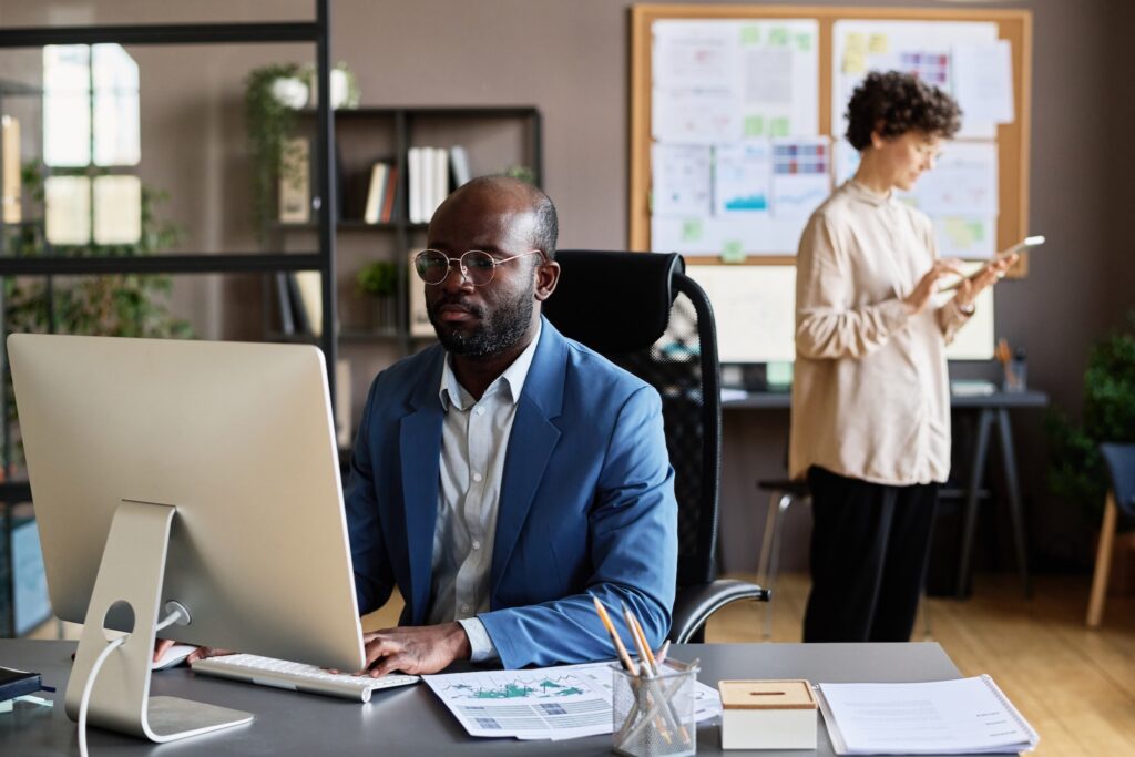 Manager using computer at work at office