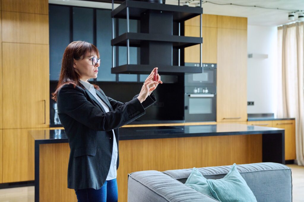 Woman real estate agent photographing furnished ap