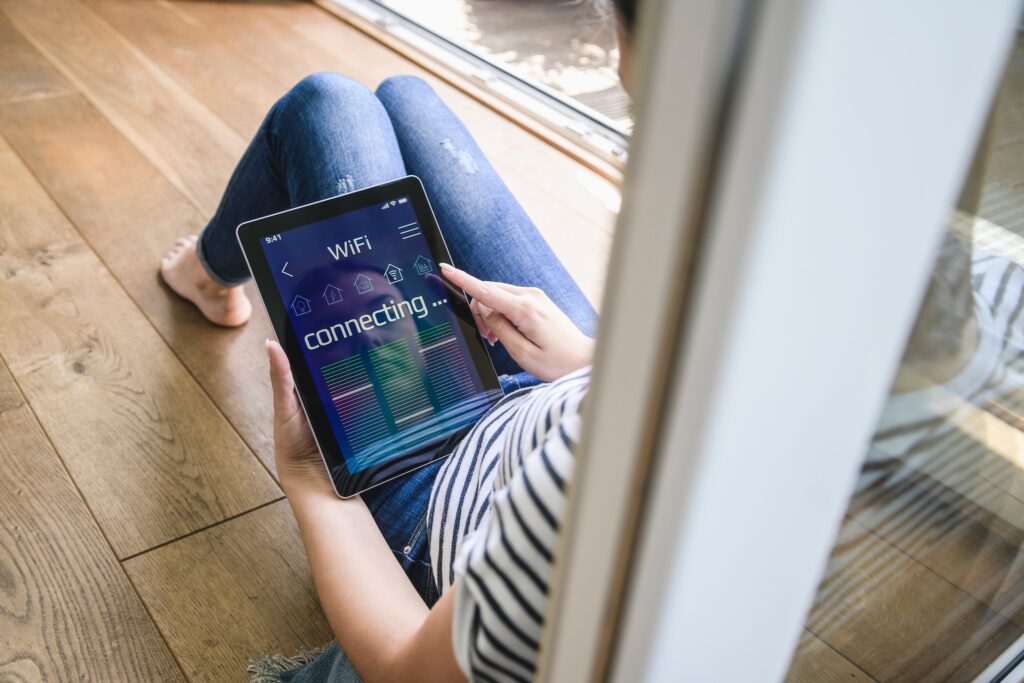 Young woman with tablet with smart home control fu